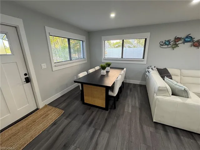 Dining area featuring dark wood-type flooring and recessed lighting