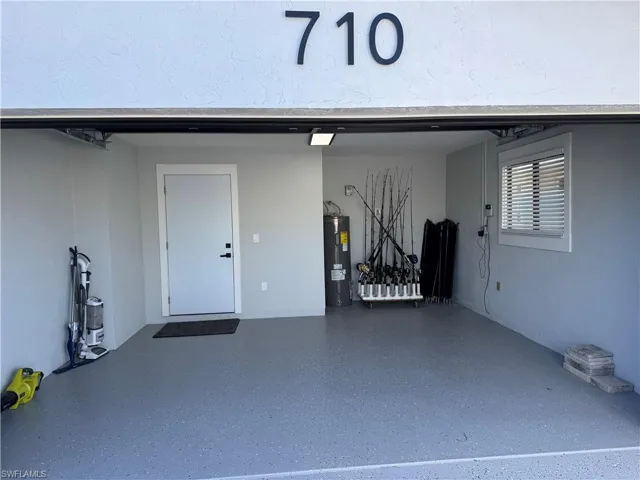 Garage featuring electric water heater