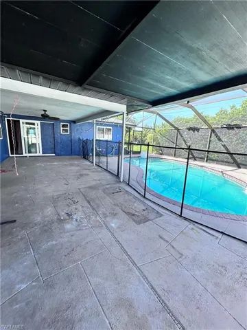 View of swimming pool with a patio and ceiling fan