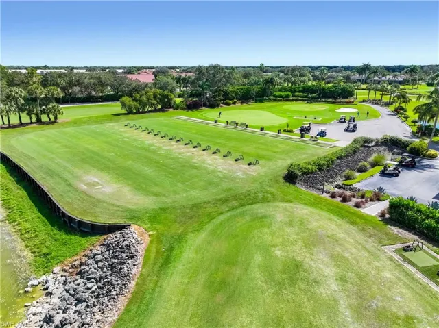 Drone / aerial view of a tree filled landscape and a golf course