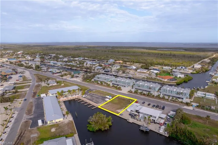 Birds eye view of property with a water view