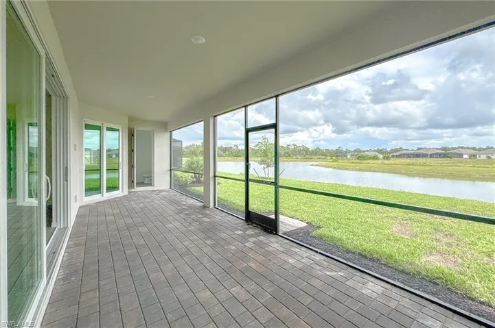Unfurnished sunroom featuring a water view