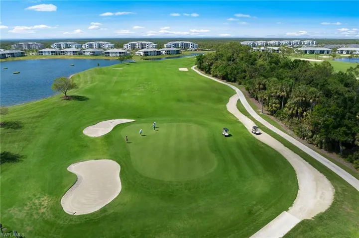 Drone / aerial view of a large body of water and a golf course