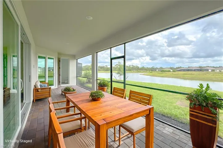 Sunroom featuring a water view