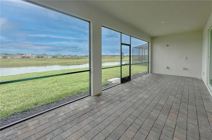 Unfurnished sunroom with a water view