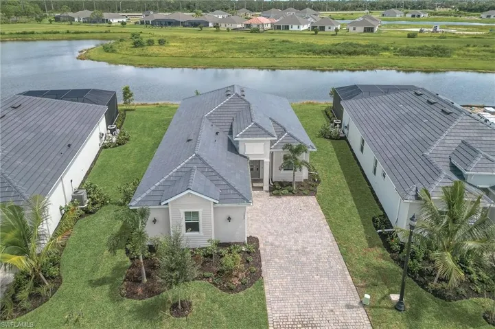 Aerial view of residential area featuring a nearby body of water