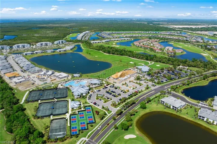 Aerial view of property's location with a local golf course and nearby suburban area
