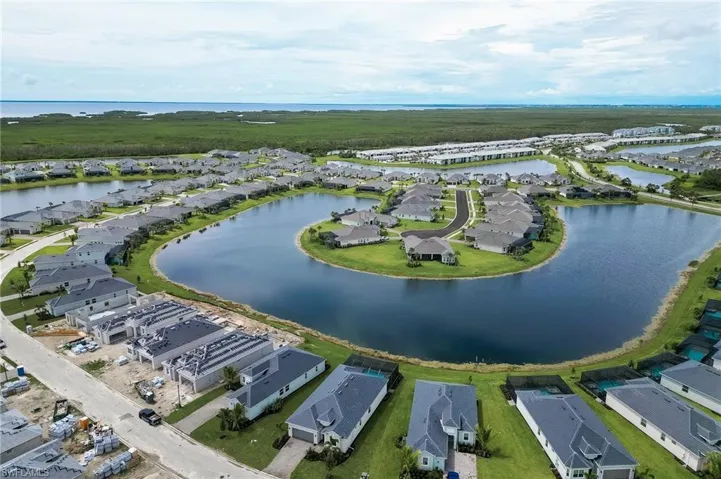 Aerial view of residential area featuring a nearby body of water