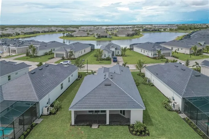 Aerial perspective of suburban area with a large body of water