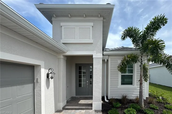 Property entrance featuring stucco siding and a tile roof