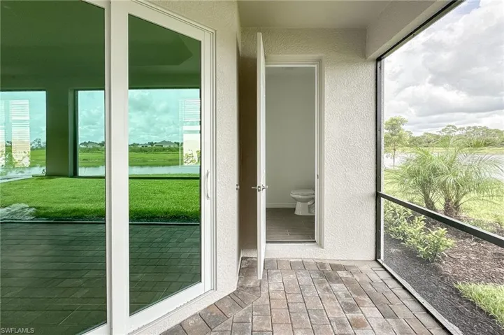 Unfurnished sunroom featuring a water view and healthy amount of natural light