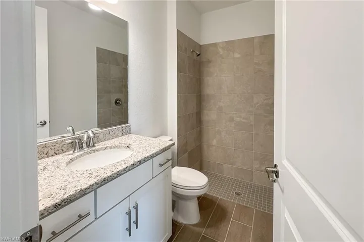 Full bath with vanity and a stall shower