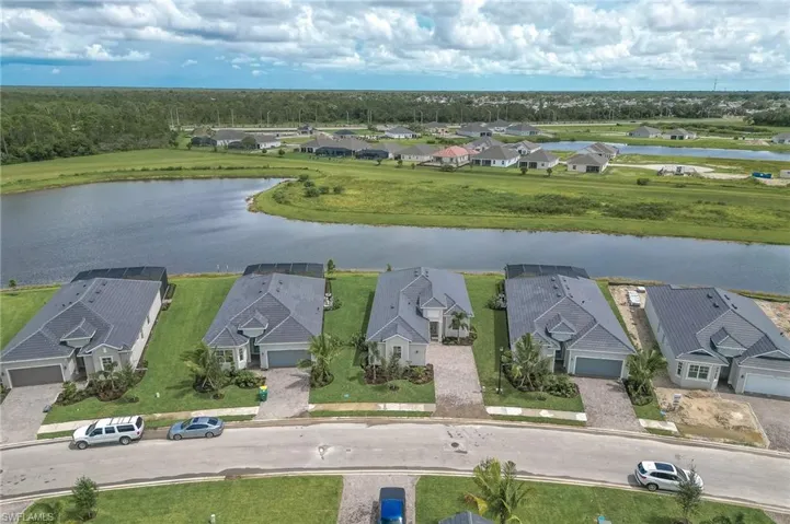 Aerial perspective of suburban area featuring a nearby body of water