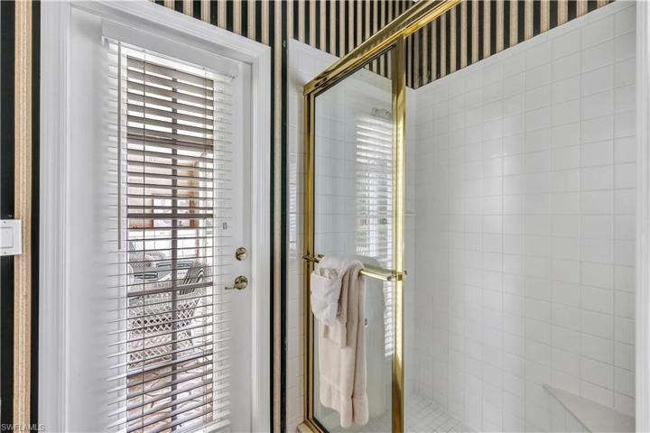 Primarybath water closet doubles as pool bath having large shower w/ built-in bench, commode, cabinet plus pocket door!