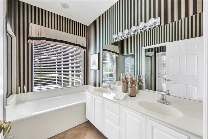 Primary Bath with pocket door to water closet/shower/pool entrance door
