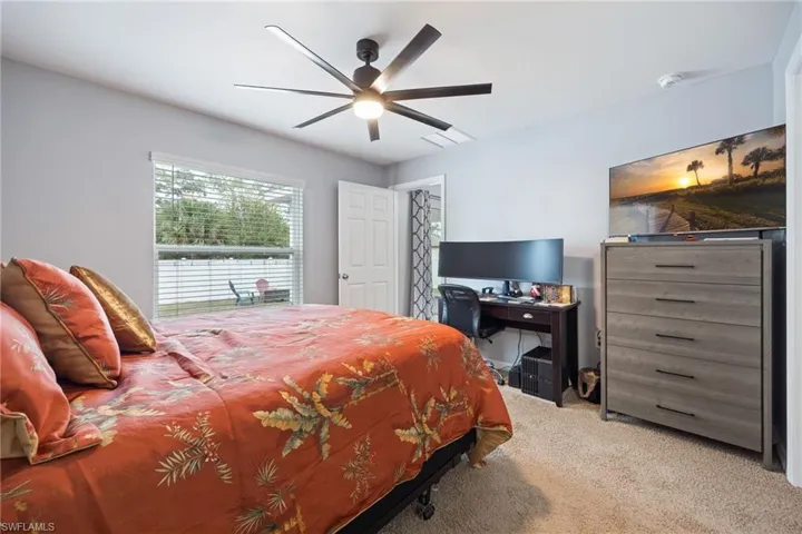 Bedroom featuring light colored carpet and a ceiling fan