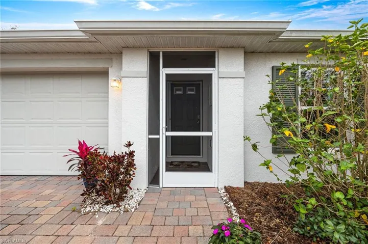 View of exterior entry with stucco siding