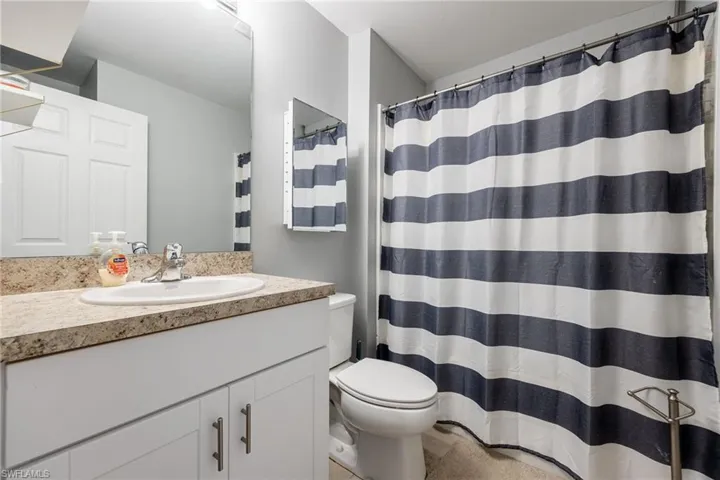 Full bath with vanity and curtained shower