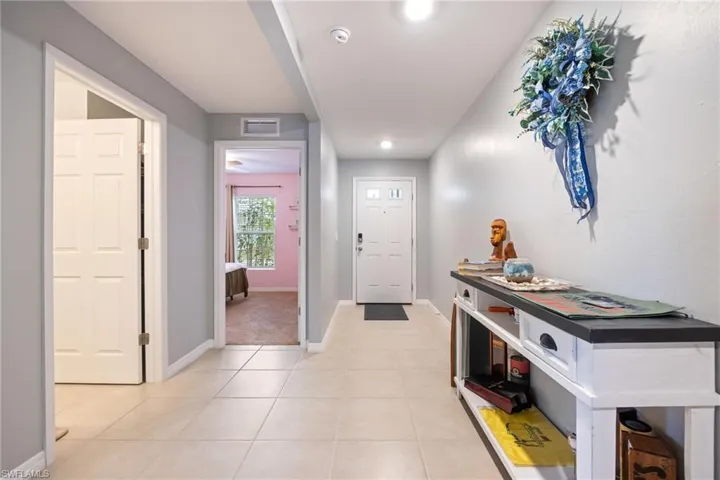 Foyer entrance featuring light tile patterned flooring and recessed lighting