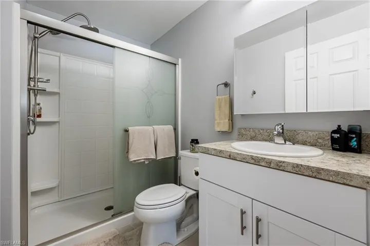 Full bath with vanity and a stall shower