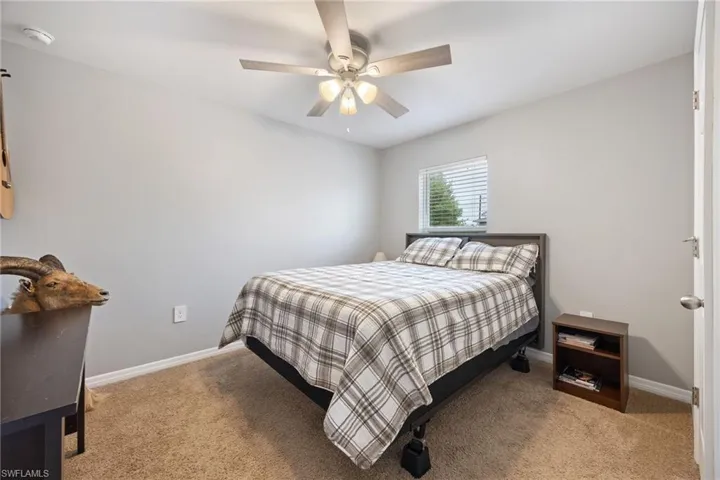 Bedroom featuring light carpet and ceiling fan
