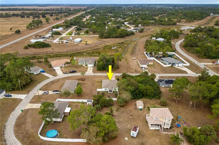 Aerial overview of property's location featuring nearby suburban area