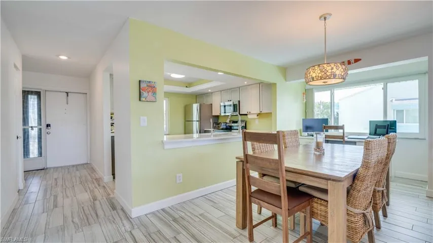Dining room featuring a raised ceiling and wood tiled floors