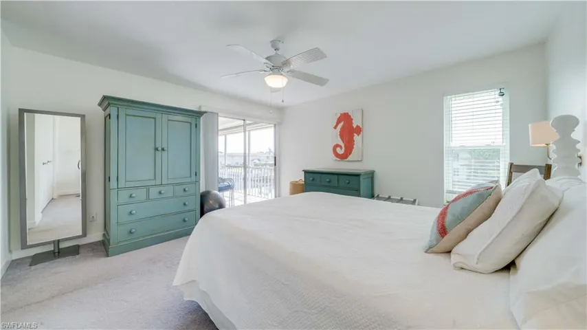 Bedroom featuring light colored carpet, access to outside, and a ceiling fan