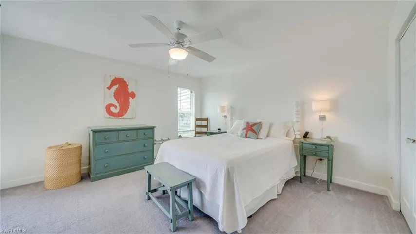 Bedroom with light colored carpet and ceiling fan