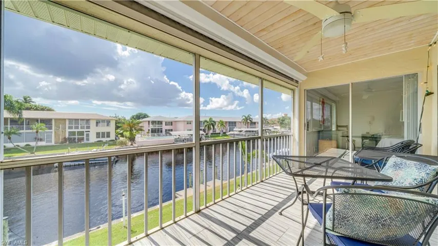 Balcony featuring a water view and a residential view