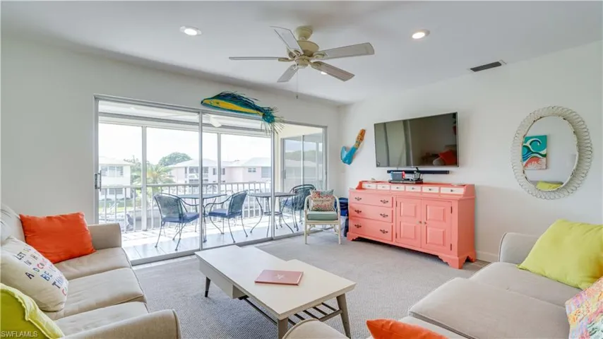 Living room with carpet floors, recessed lighting, and ceiling fan