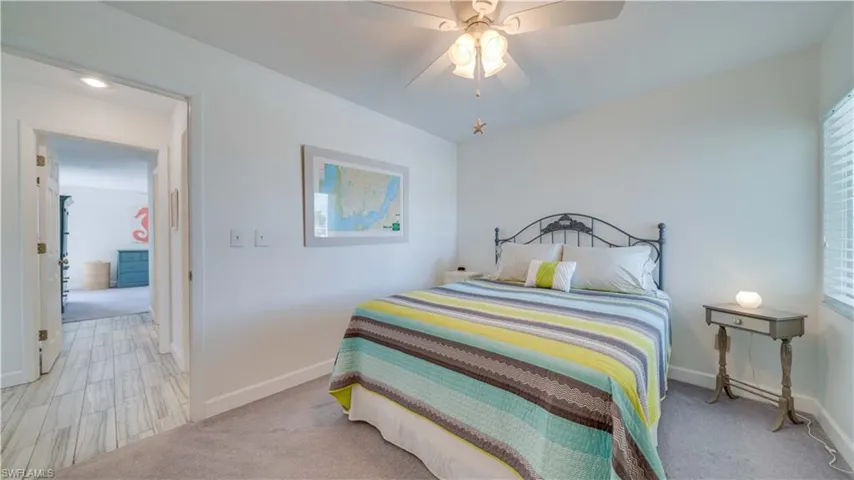Bedroom with light carpet and ceiling fan