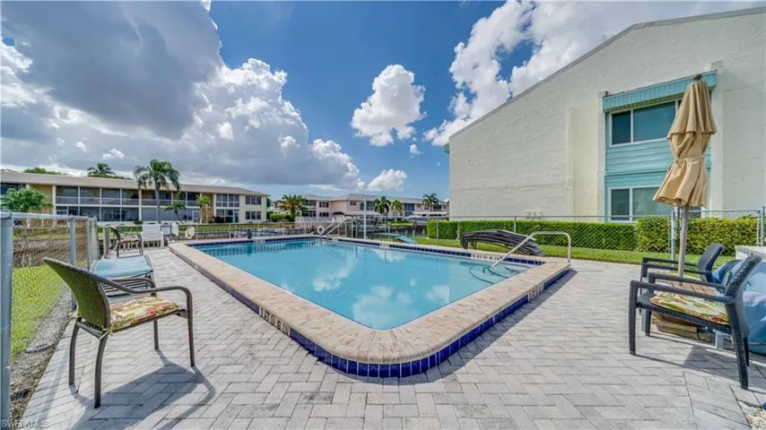 Community pool with a patio