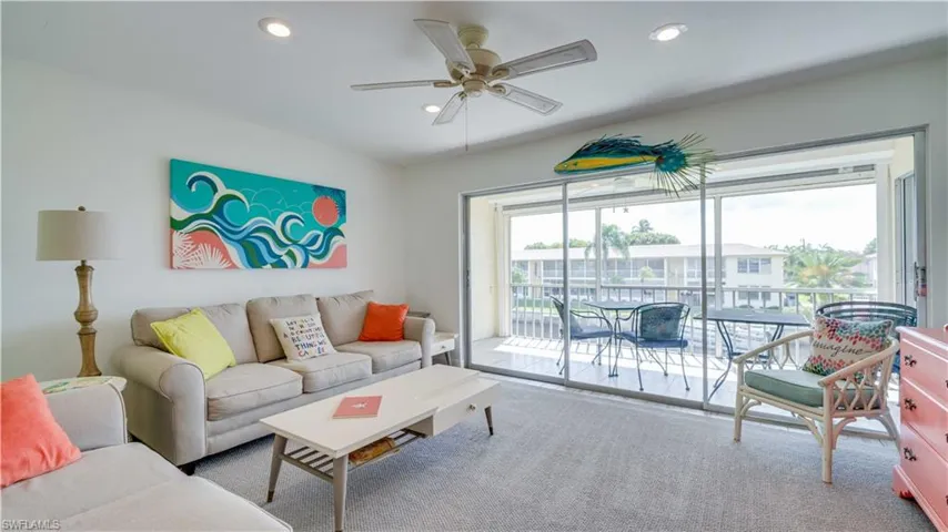 Living room with recessed lighting, carpet flooring, and a ceiling fan