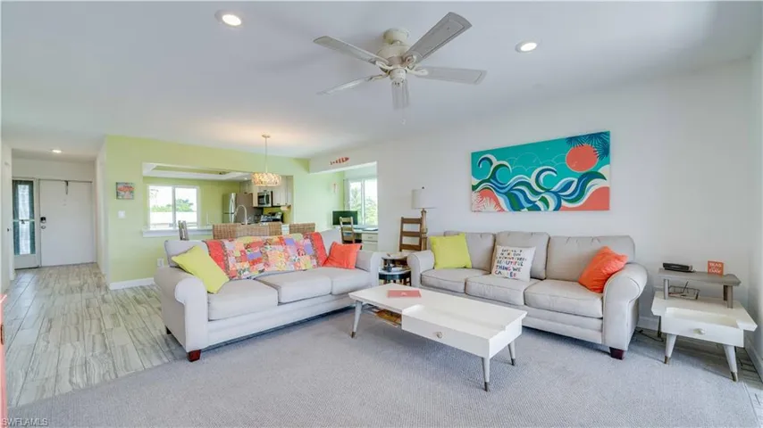 Living room featuring recessed lighting, light wood finished floors, and ceiling fan