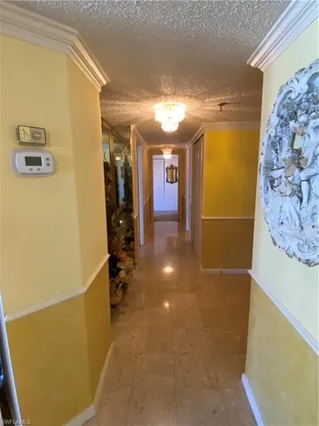 Corridor featuring Mable Floor, ornamental molding