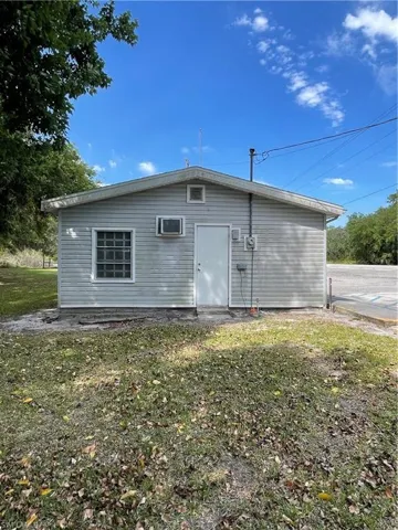Rear view of house with a yard