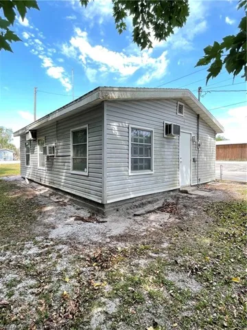 View of side of property with a wall mounted AC