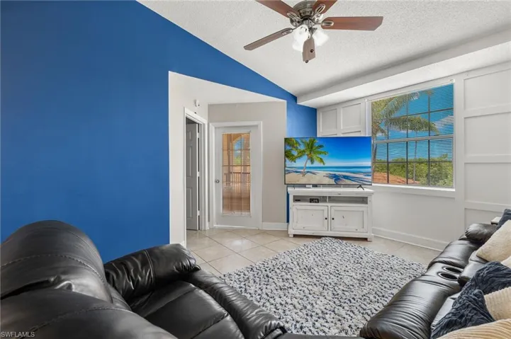 Living room w/ wall treatments and vaulted ceilings.