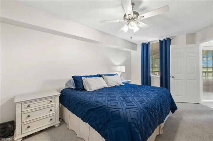 Primary bedroom with ensuite bath, and ceiling fan.