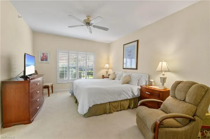 Primary bedroom,  featuring carpet, ceiling fan and baseboards