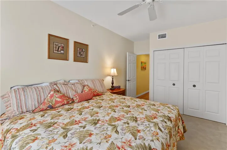 Bedroom with carpet flooring, a closet, and a ceiling fan
