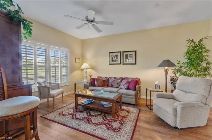 Living area featuring light wood-style floors and ceiling fan