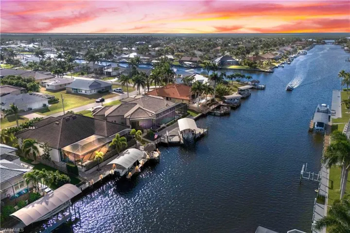 The BEST of waterfront living with an expanded outdoor area, boatlift, expansive pavered backyard/boat deck and a canopied lift and boat.  Tiki hut is the PERFECT place to kick back and watch both the sunrise and sunset!