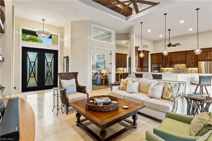 Inviting view from the poolside lanai toward the front entrance.  Custom beams, transom window for natural light - everywhere you look there are tasteful and subtle touches which make this home stand out amongst the rest!