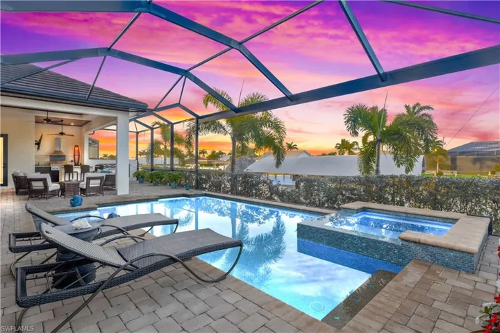 Tranquil poolside retreat with ambient lighting, perfect for evening swims while watching spectacular sunsets paint the sky over the waterway.  Sparkling pool and heated spa and multiple outdoor seating areas - not your average home!
