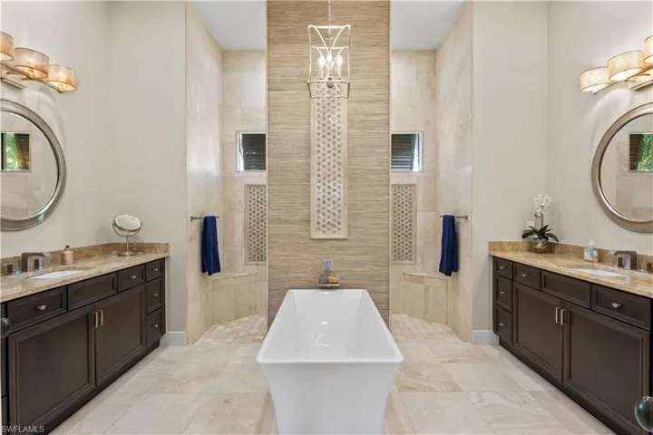 Luxurious master bath with travertine floors, soaking tub, perfect for unwinding.