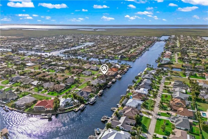 Elevated perspective highlighting the home’s private location and stunning Cape Coral surroundings.