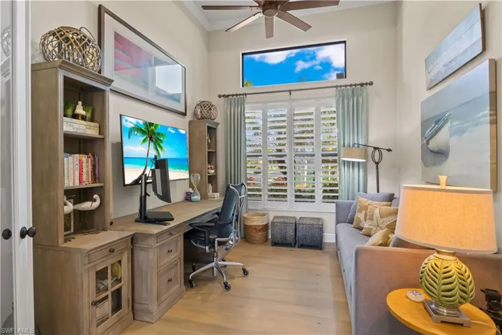 Elegant study featuring custom cabinetry, rich flooring, and a tranquil workspace.