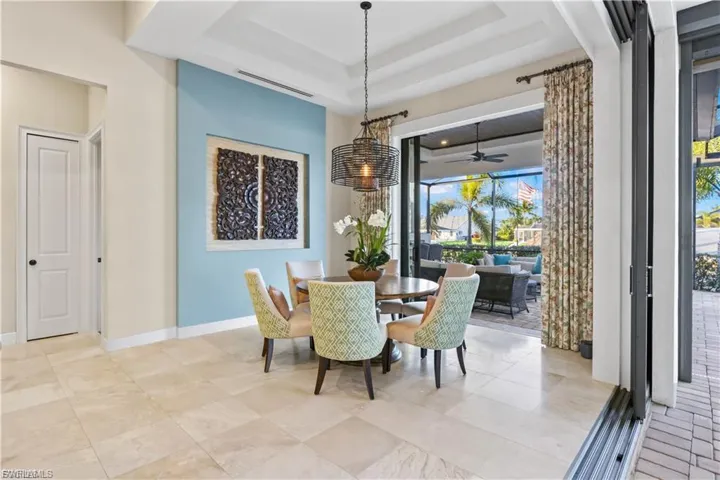 Light-filled dining room featuring premium finishes and seamless access to the outdoor living space.